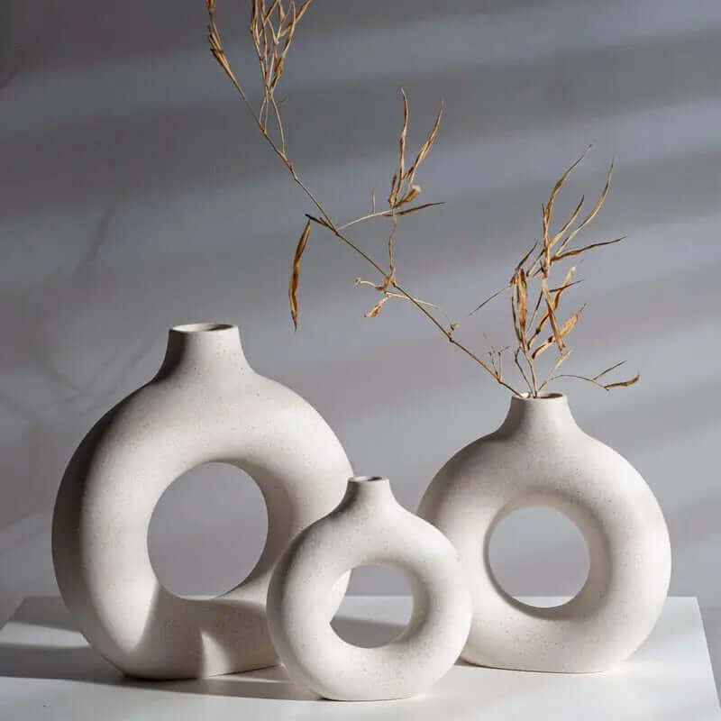 Set of three white vases with a sleek, round design