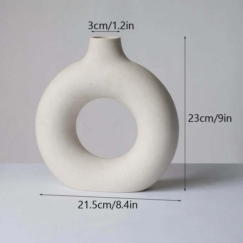 Modern white vase featuring a unique central aperture